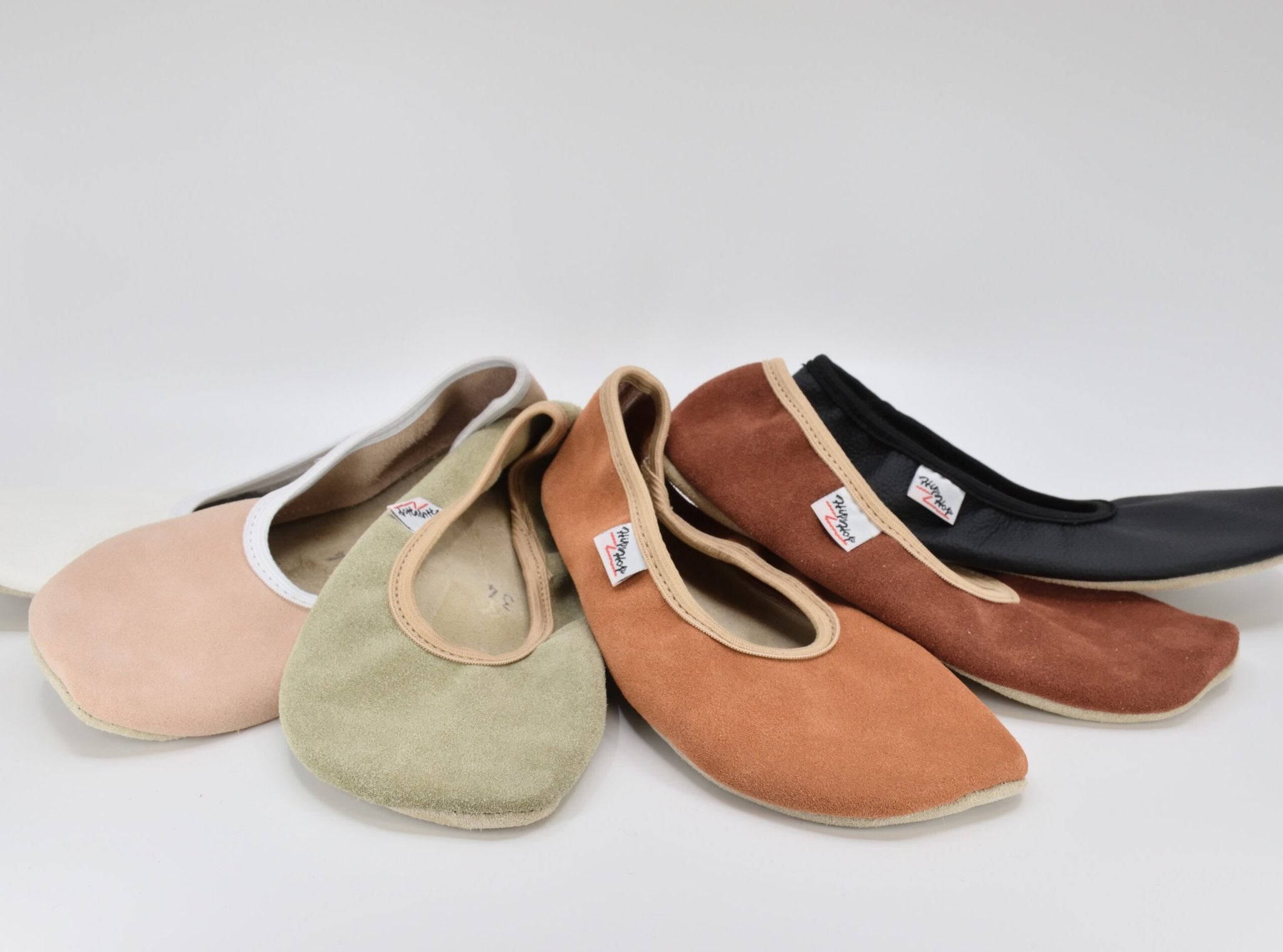 5. Close-up of Hip-Hop barefoot slippers in terracotta, green, and black, highlighting leather material and design
