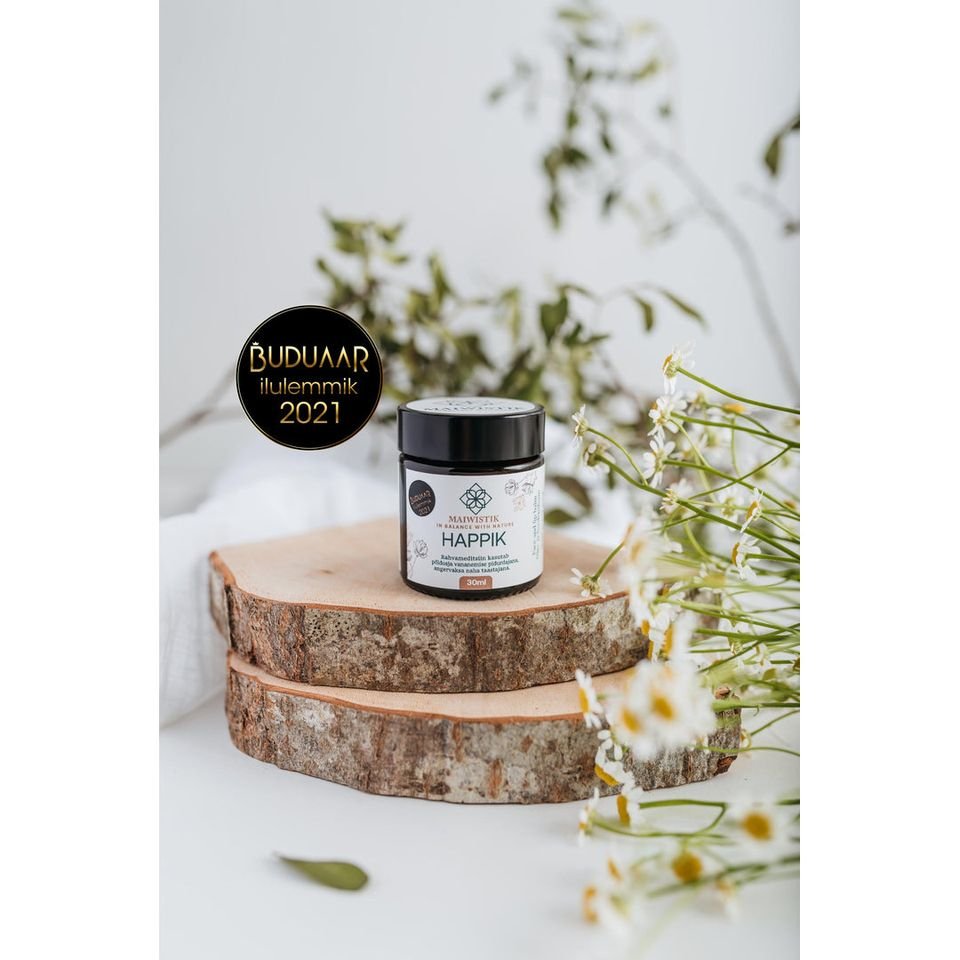 1. MaiWistik HAPPIK Rejuvenating Face Balm 30ml displayed on wooden slices with flowers, showcasing natural ingredients and award recognition