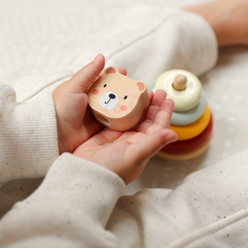 13. Child holding bear head from Woopie Let's Go Green 3in1 toy set with pyramid in background