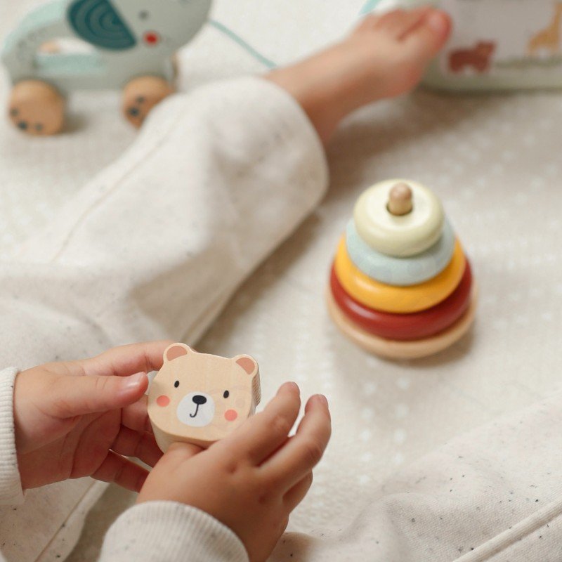 10. Child holding bear head from pyramid in Woopie Let's Go Green 3in1 toy set