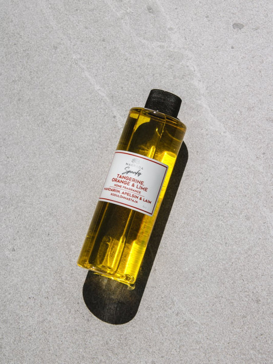 1. Magrada Organic Cosmetics Spunky home fragrance refill bottle with tangerine, orange, and lime scent, shown on a textured surface