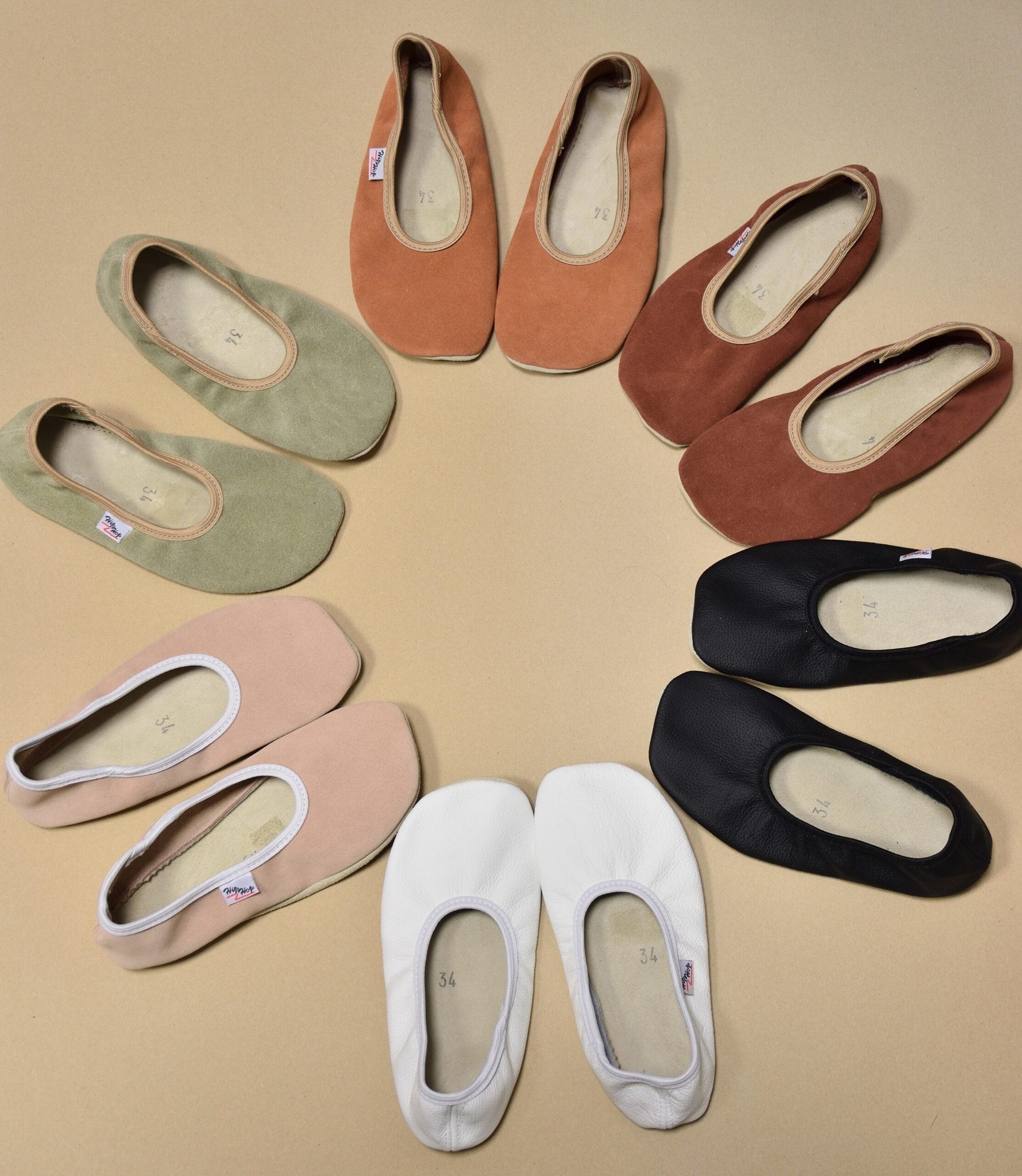 5. Flat lay of various colored barefoot slippers by Hip-Hop, including black, white, and pastel shades