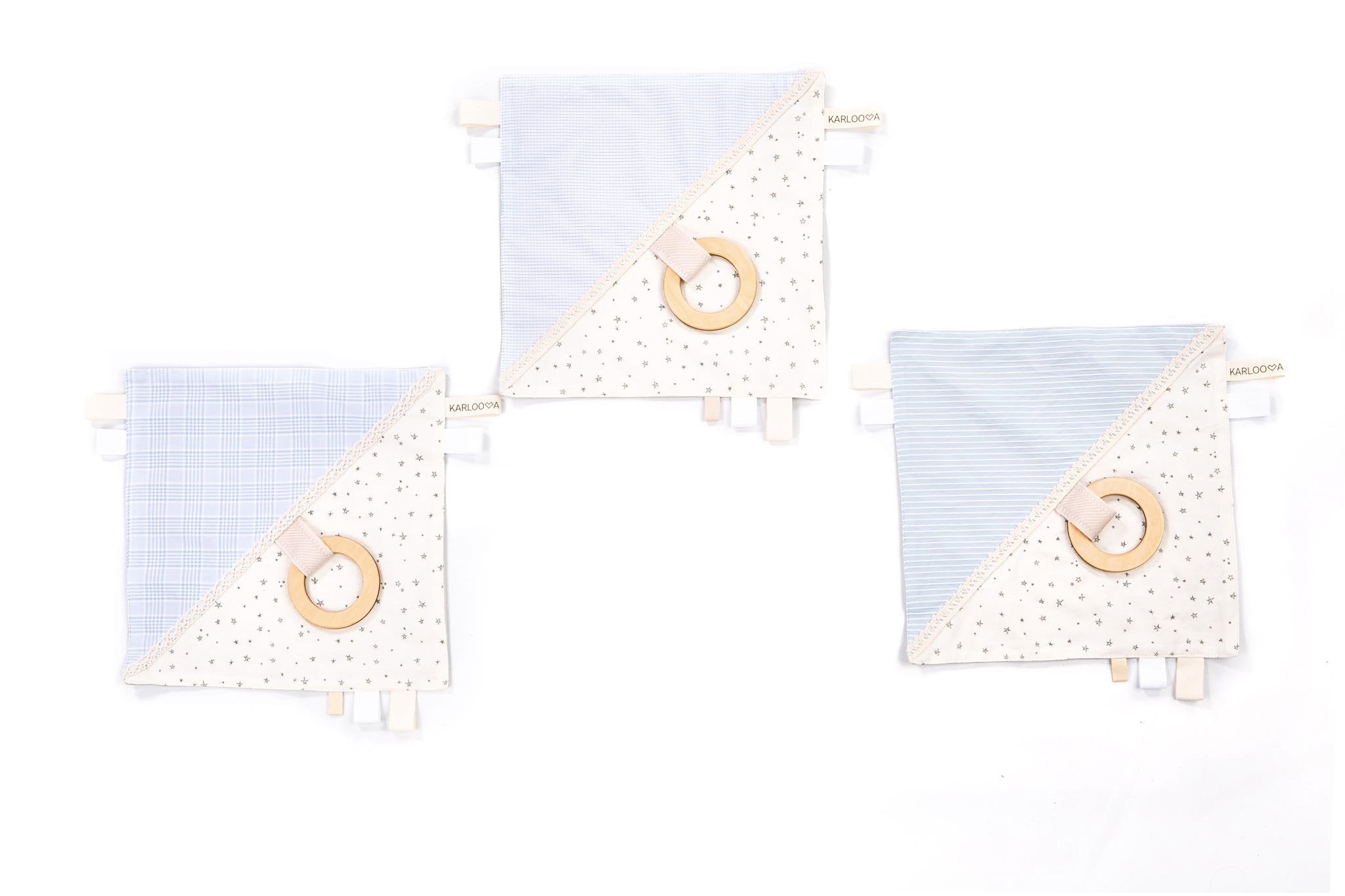 4. Three Karloova comfort blankets with blue and white fabric, wooden hoops, and star patterns on white background