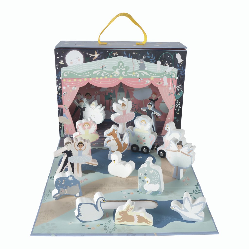 1. Enchanted playbox with wooden characters including ballerinas and swans on a stage with a magical forest backdrop