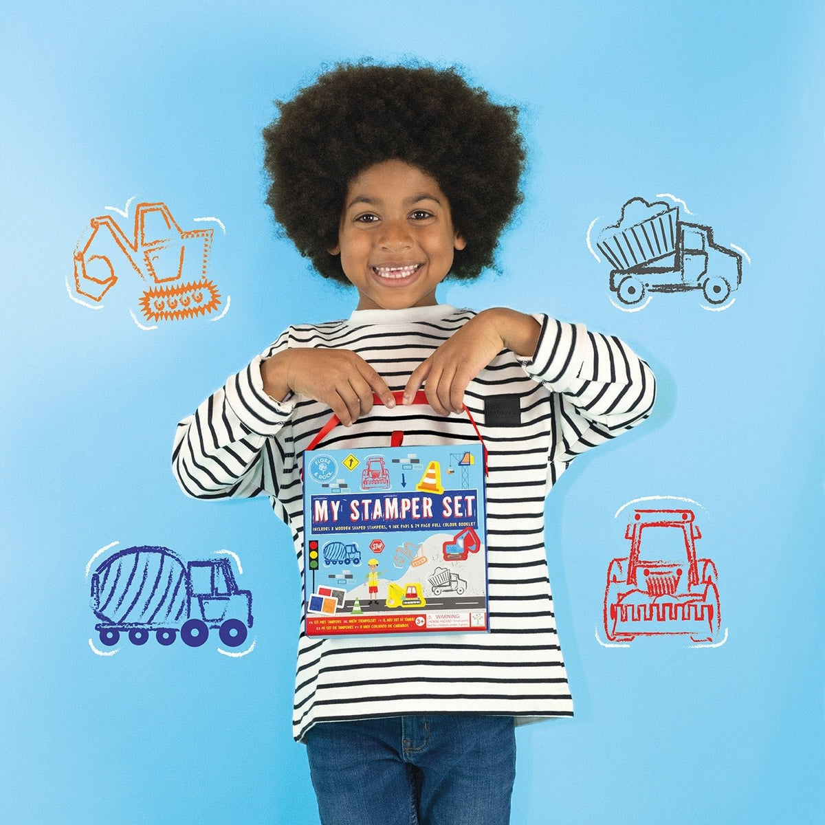 1. Child holding My Stampler Set against blue background with construction vehicle illustrations