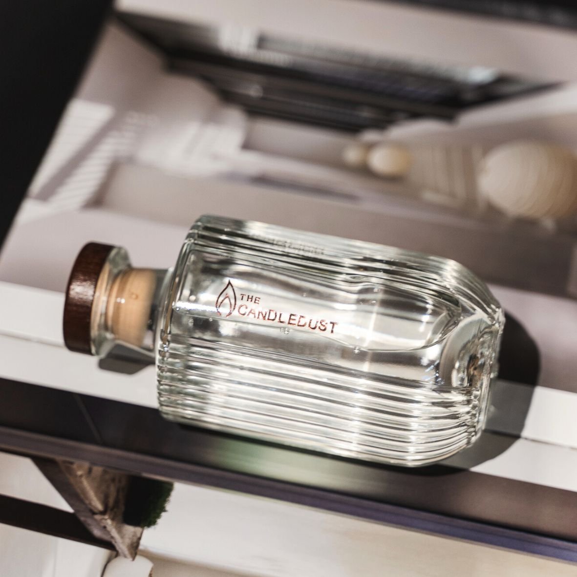 8. Close-up of Candledust Breeze diffuser bottle with brand logo on stylish background