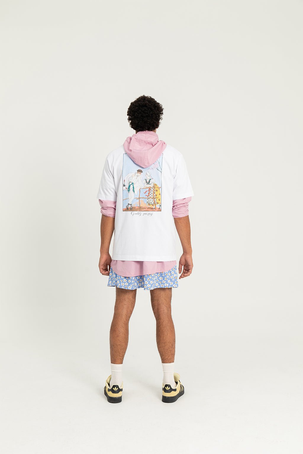4. Male model wearing Hopera's 'Gentils Propos' t-shirt by George Barbier, shown from the back in studio