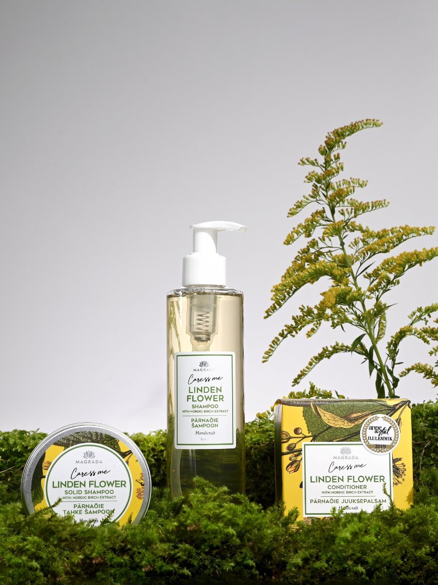 3. Magrada Organic Cosmetics Linden Flower hair care set including shampoo, solid shampoo, and conditioner on moss with floral background