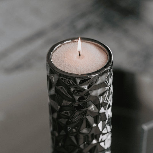 2. Lit Candledust powdered candle in a textured black container, creating a cozy atmosphere