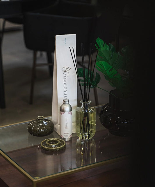 2. Candledust Signature room diffuser with packaging and additional fragrance bottle on a stylish table