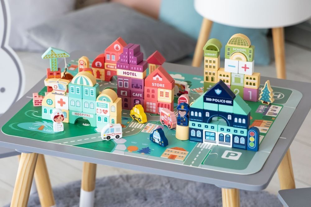 10. Wooden city set on table with hospital, store, and police station