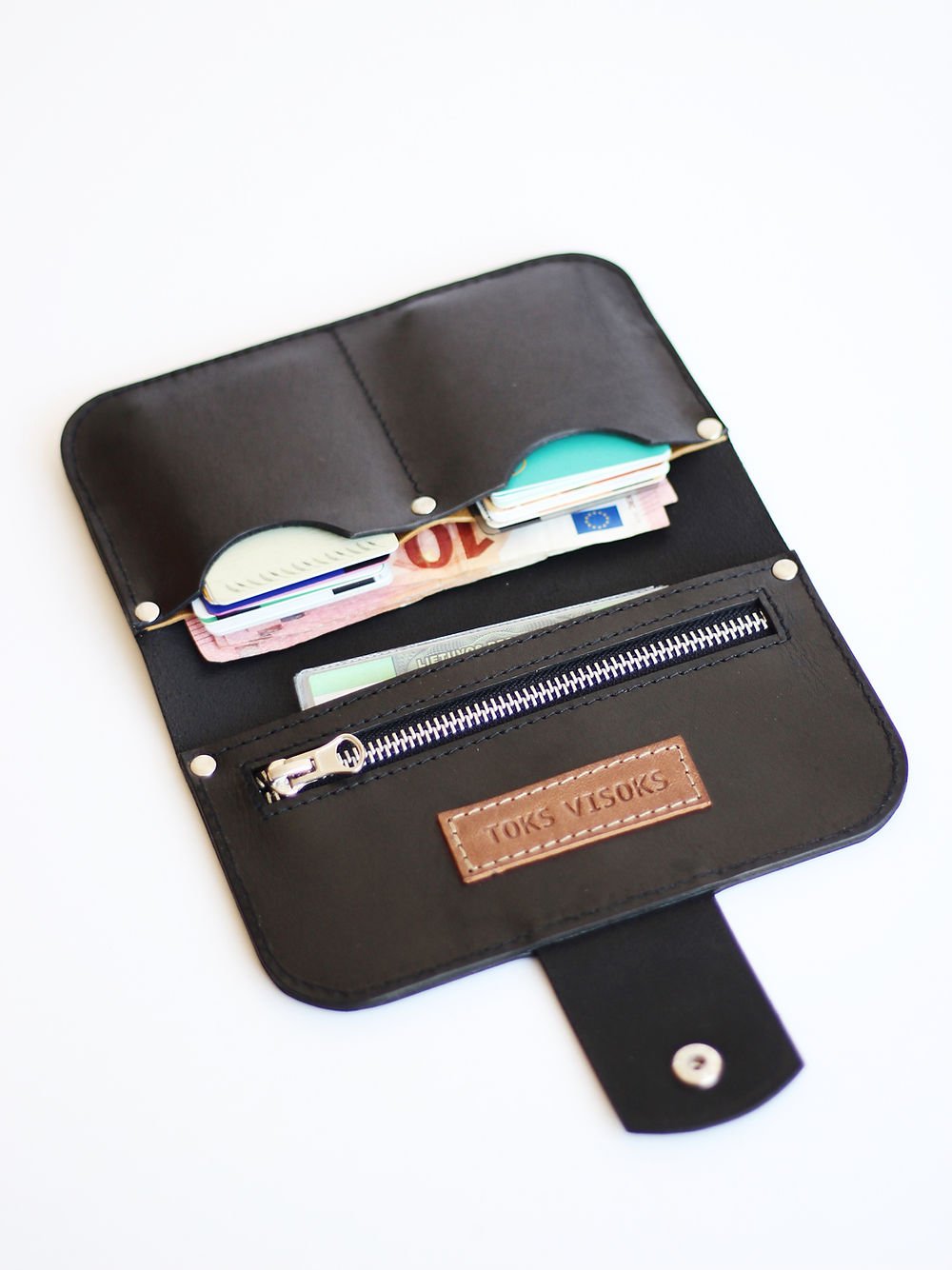 4. Close-up of open black SATURDAY wallet by TOKS VISOKS, showing brand logo and organized compartments