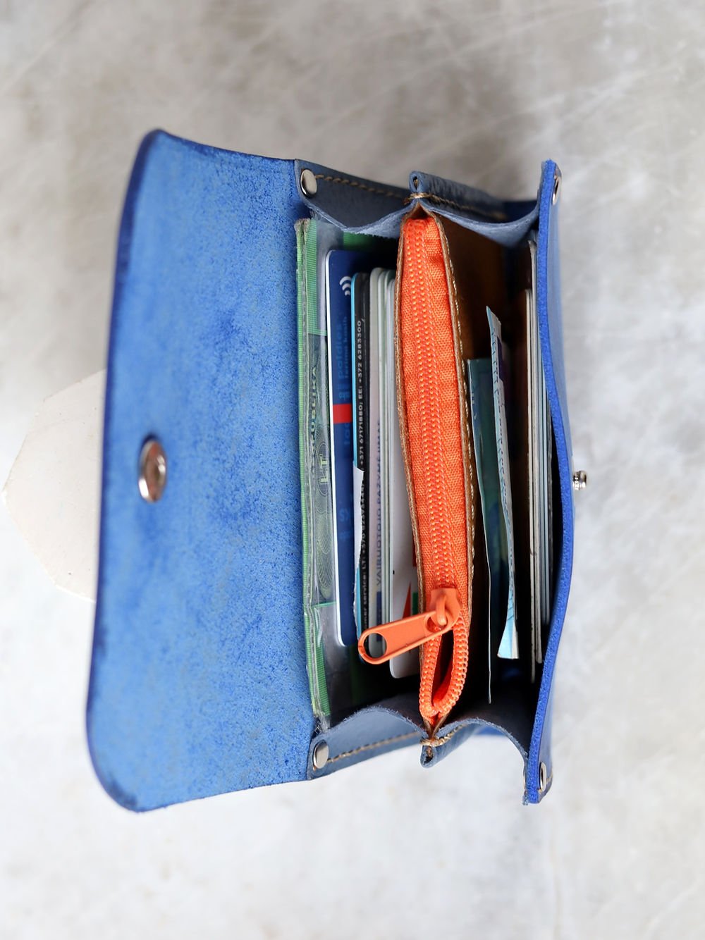3. Inside view of blue TOKS VISOKS FRIDAY Wallet, highlighting secure coin pocket with orange zipper