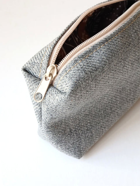 4. Close-up of TOKS VISOKS LORNA grey makeup bag zipper detail and texture