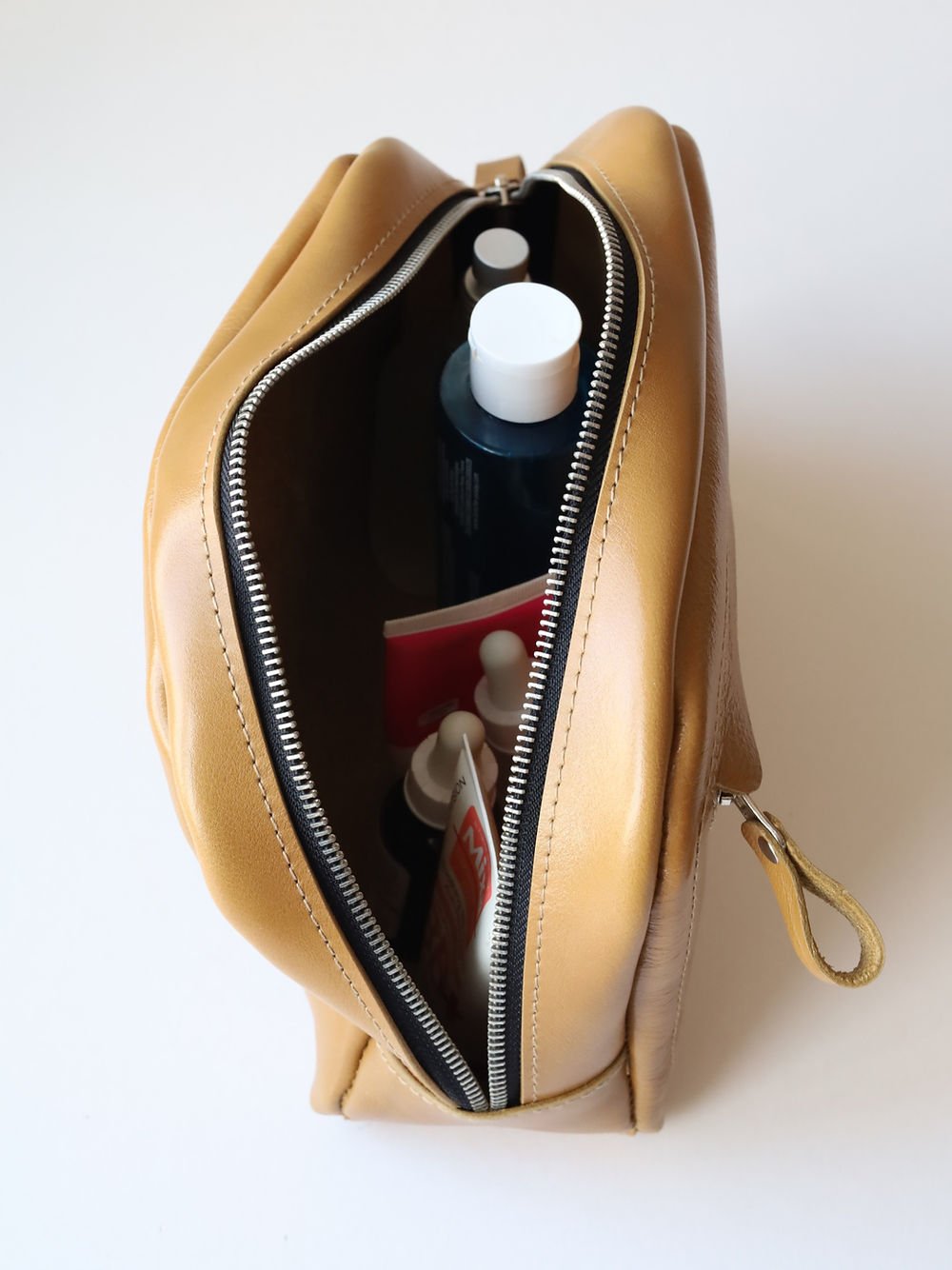 1. Open DOUGLAS Toiletry Bag in mustard showing spacious interior with beauty essentials, TOKS VISOKS brand