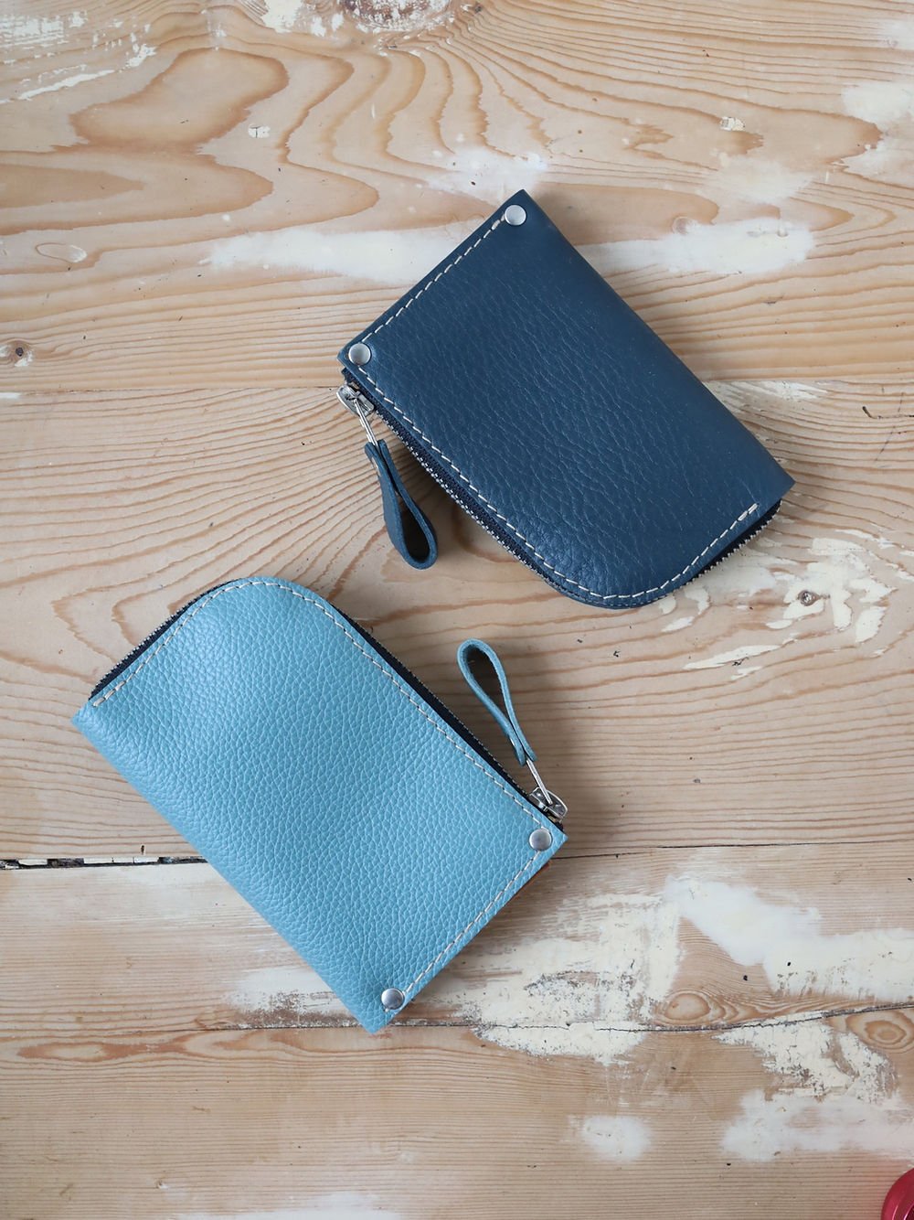 3. Flat lay of two TOKS VISOKS WEDNESDAY Wallets in turquoise and navy, showcasing compact design