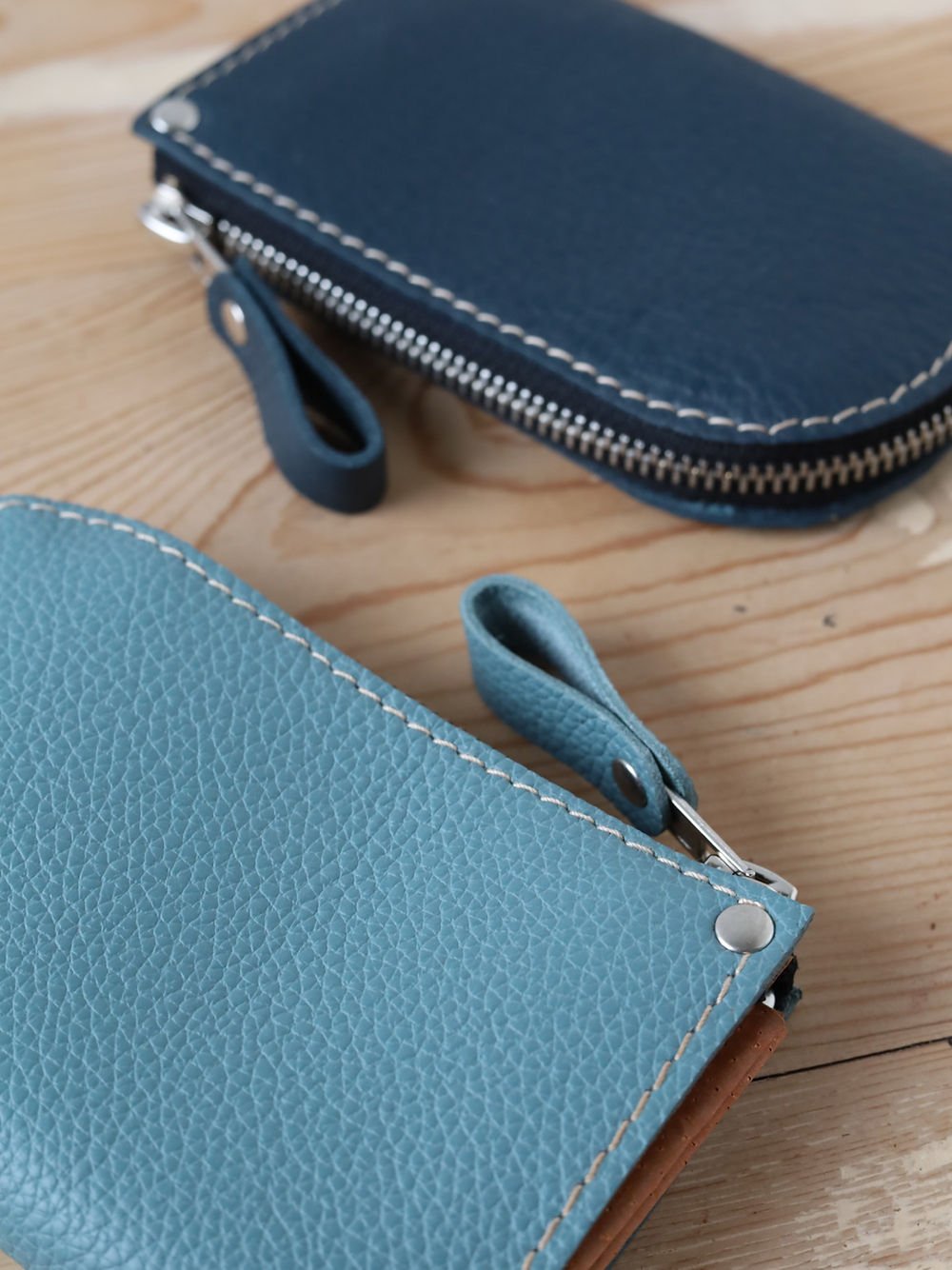 5. Close-up of turquoise and navy TOKS VISOKS WEDNESDAY Wallets, focusing on texture and zipper