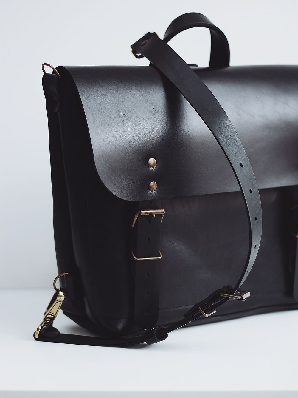 5. Studio shot of black leather BENJAMIN Backpack by TOKS VISOKS with adjustable strap