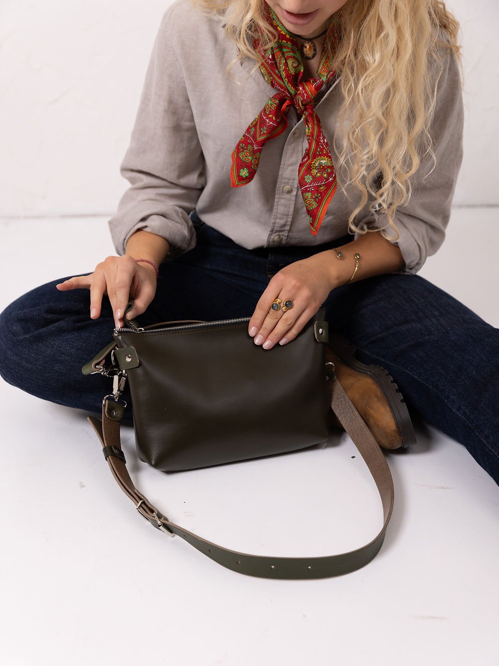 4. Close-up of women's TOMMY leather bag in dirty green, showcasing removable strap and secure zipper