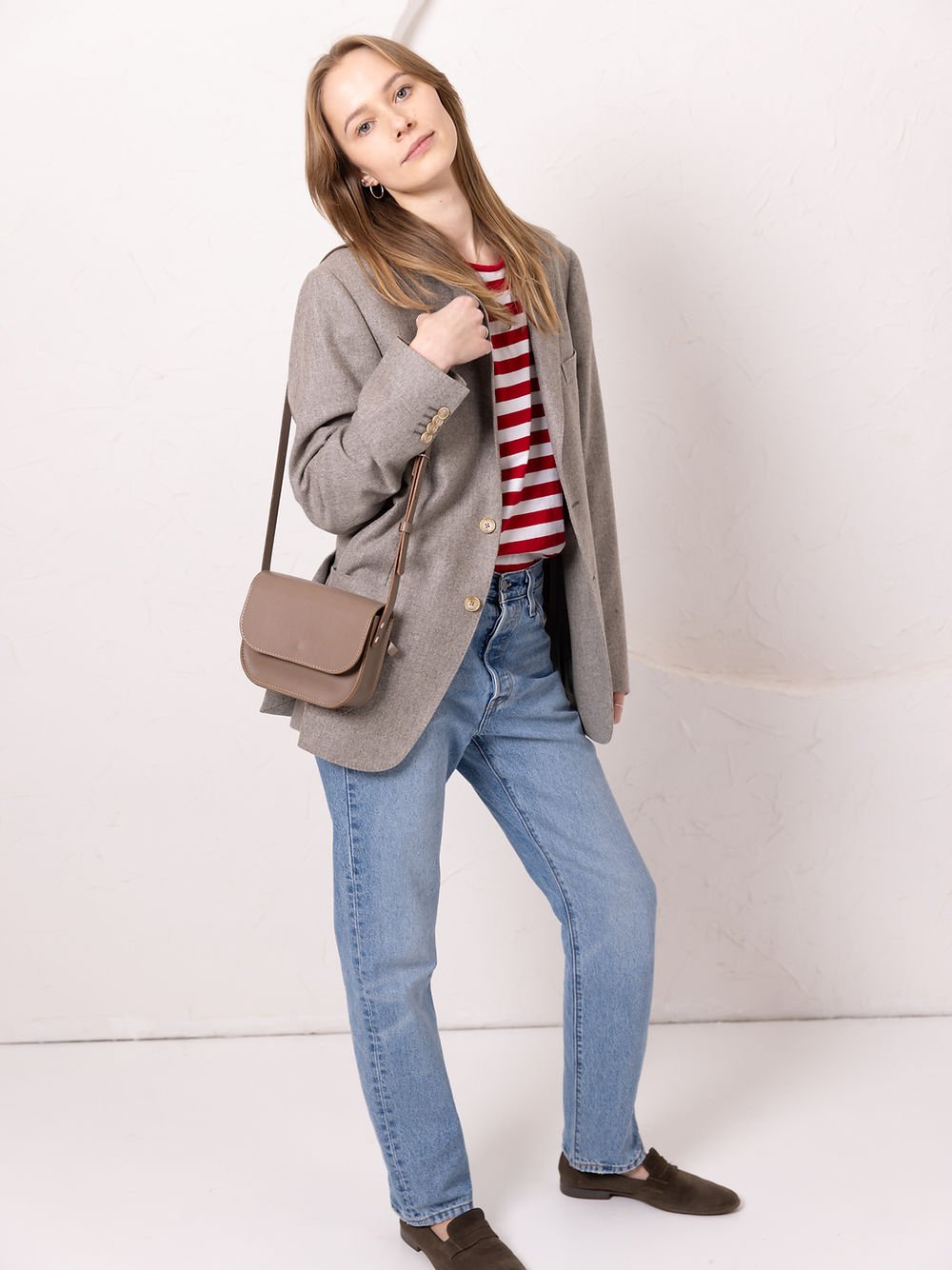 8. Woman wearing TOKS VISOKS RUBY Purse in beige, styled with casual outfit, lifestyle setting