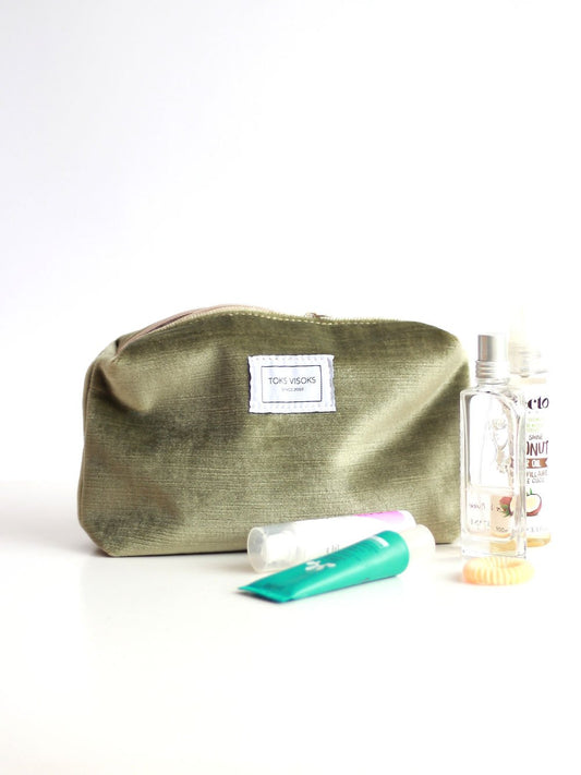 1. LORNA Makeup Bag in olive velvet by TOKS VISOKS, shown with beauty products, highlighting spacious design