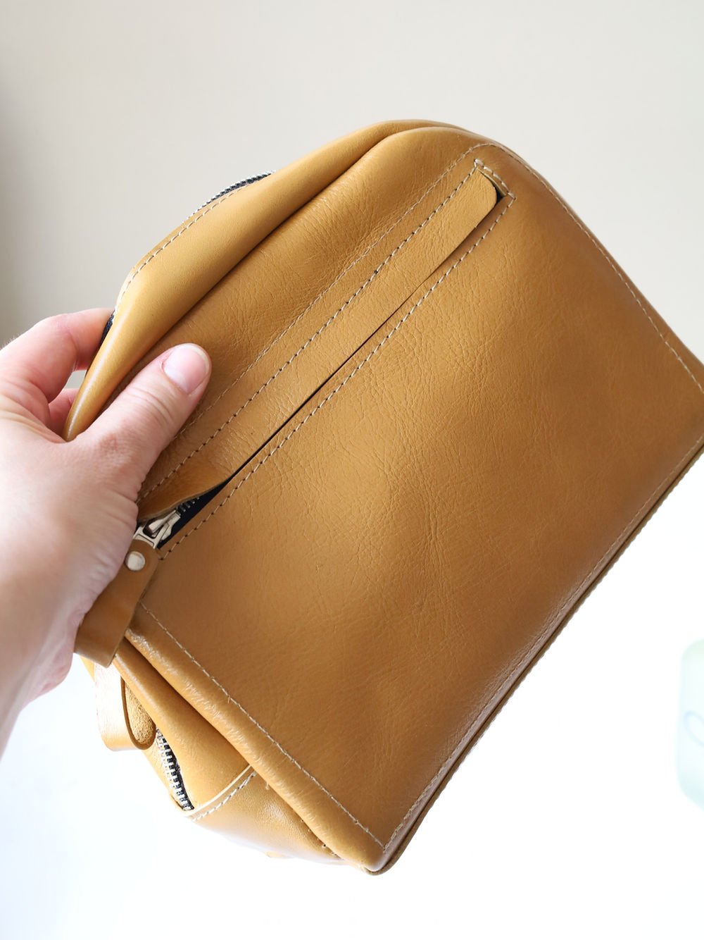 2. Back view of DOUGLAS Toiletry Bag in mustard with additional zipped pocket, TOKS VISOKS brand