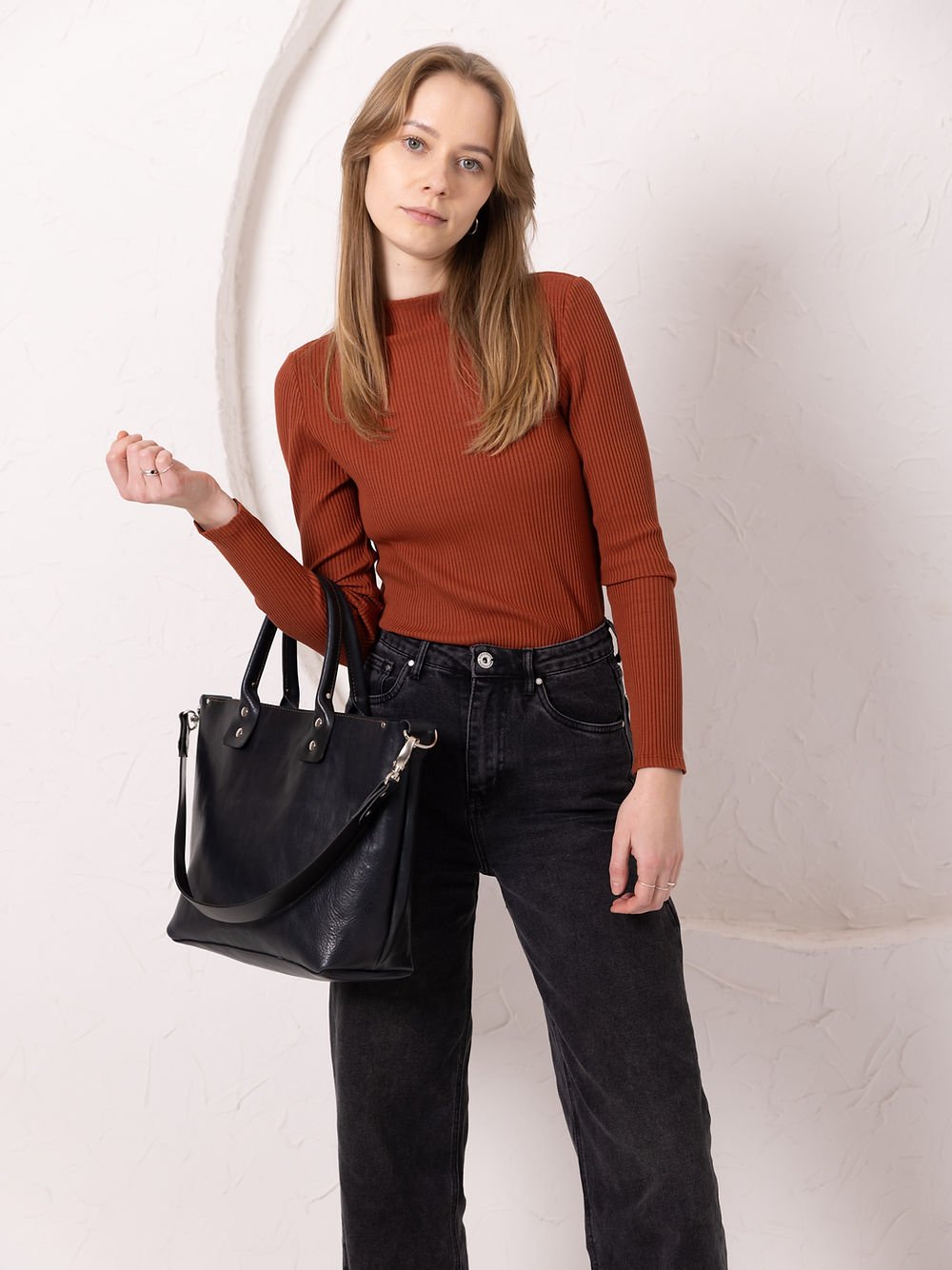 5. Women's MIGLE Leather Handbag in Dark Denim by TOKS VISOKS, held by handles in lifestyle setting
