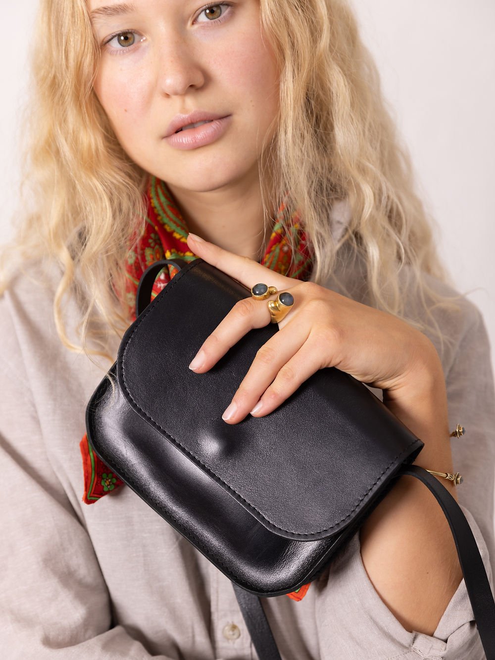 9. Close-up of black RUBY Purse by TOKS VISOKS held by woman, showcasing leather texture