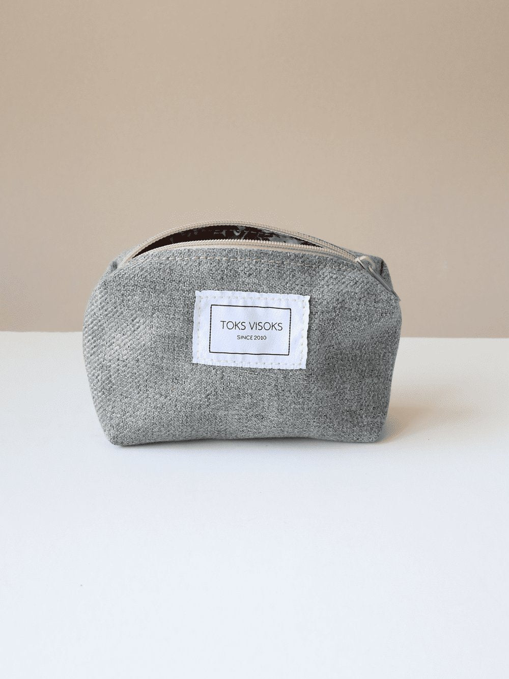 5. Front view of TOKS VISOKS LORNA grey makeup bag in studio