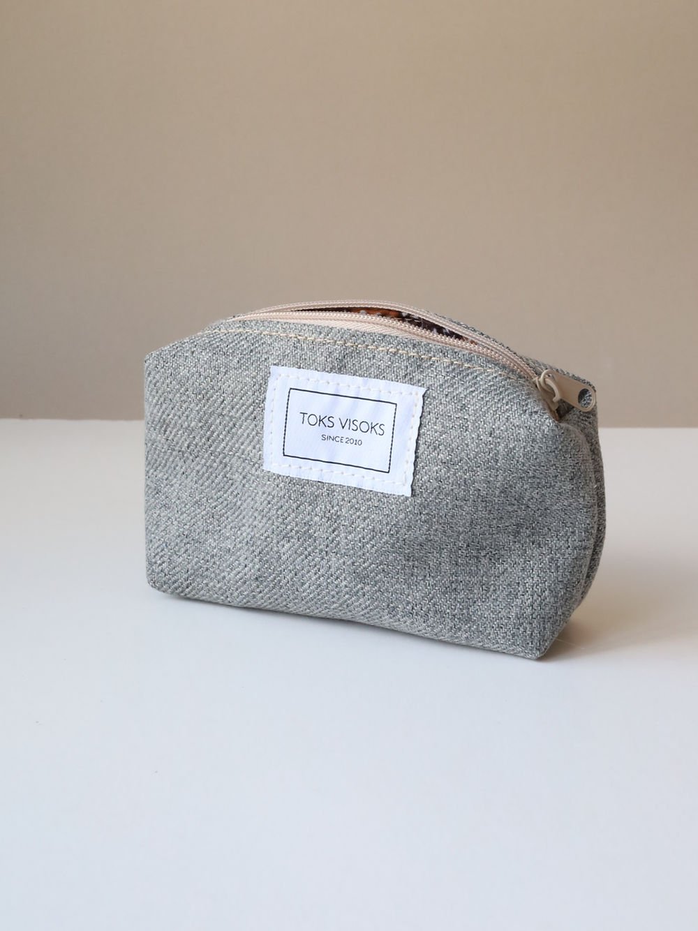 2. Studio shot of TOKS VISOKS LORNA grey makeup bag with visible brand label