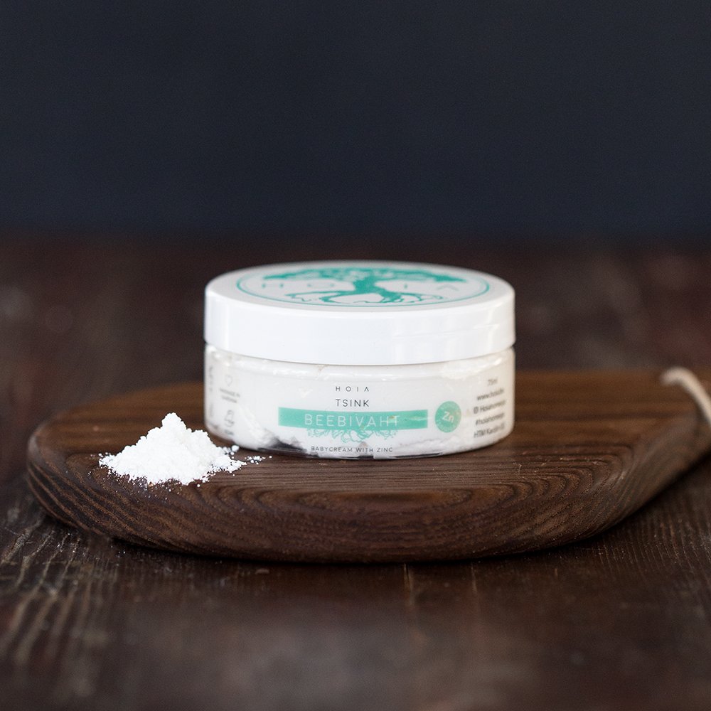 1. HOIA homespa Babycream with Zinc, 75ml jar on wooden board, showcasing natural skincare product for babies
