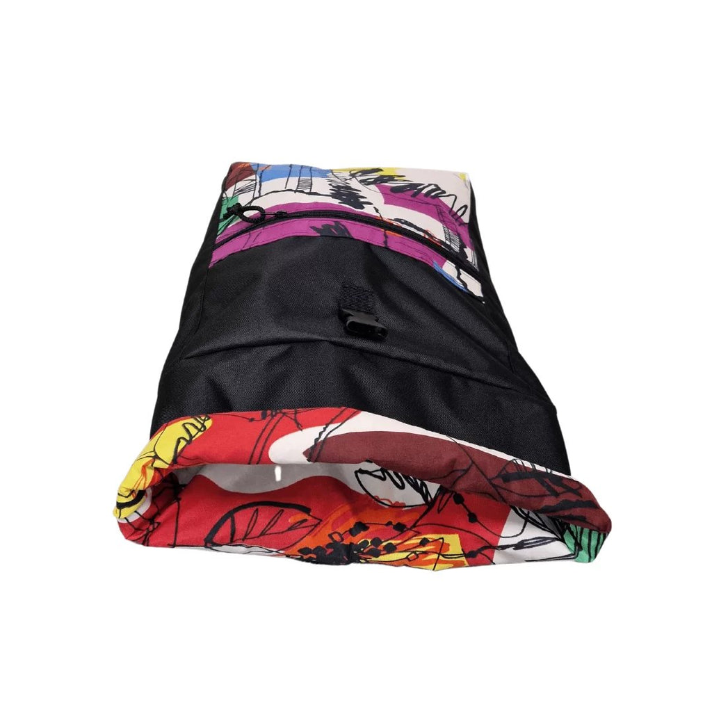 2. Drinbags PAINT waterproof backpack laid flat, showing colorful design and roll-top feature, studio shot
