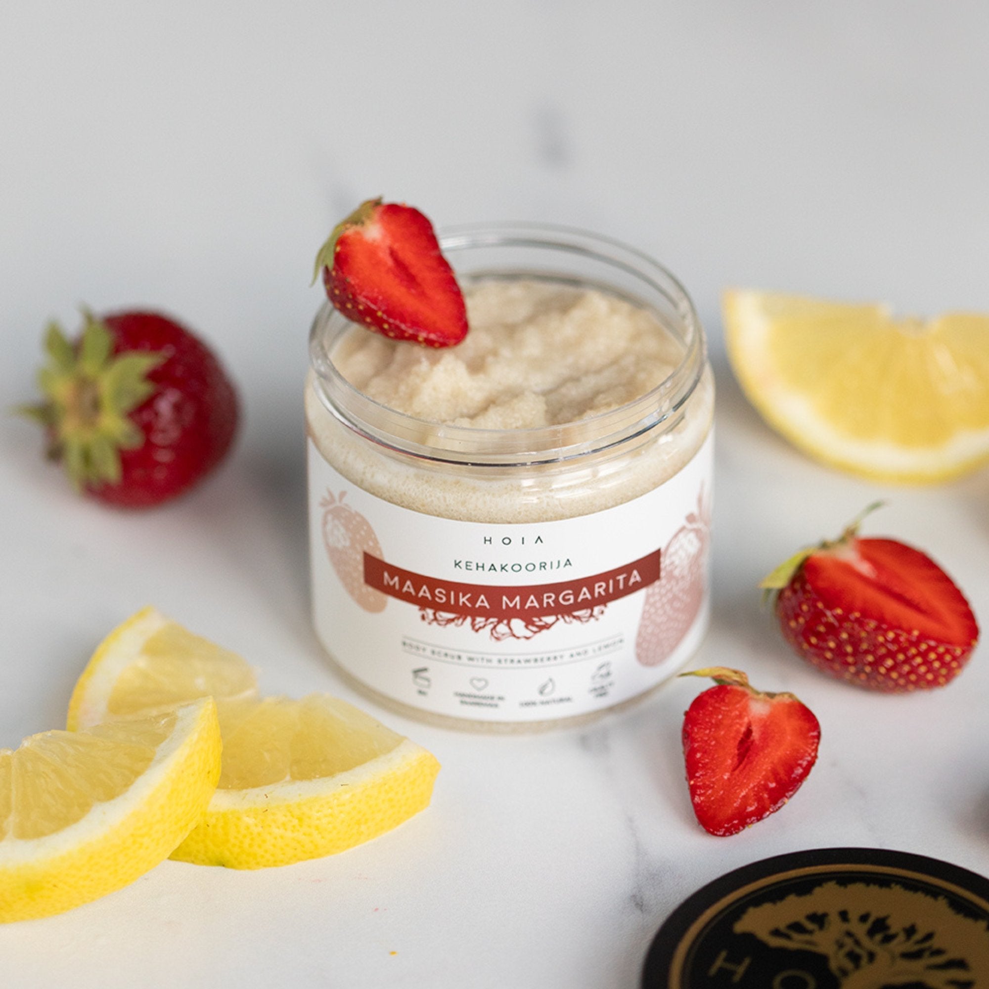3. HOIA homespa Strawberry Margarita body scrub with fresh strawberries and a bowl of scrub on a pink background