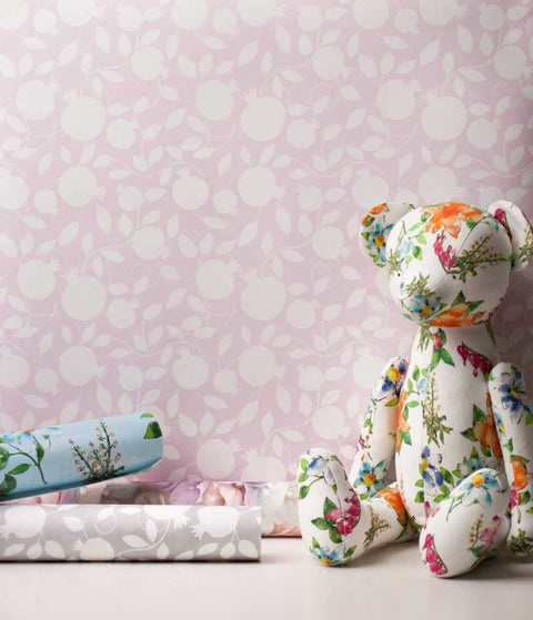 2. Pomegranate pink wallpaper with floral teddy bear and rolled wallpapers in a room setting