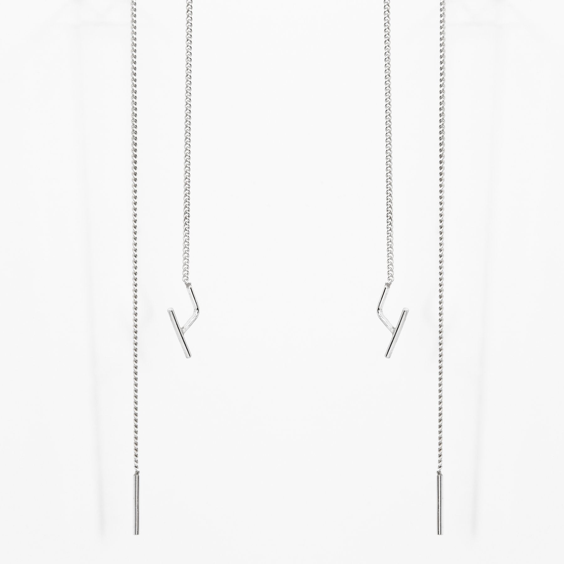 2. Studio image of Maarja Palu SWING earrings with long silver chains and minimalist design