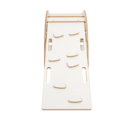 2. White wooden slide with climbing grips attached to rocker