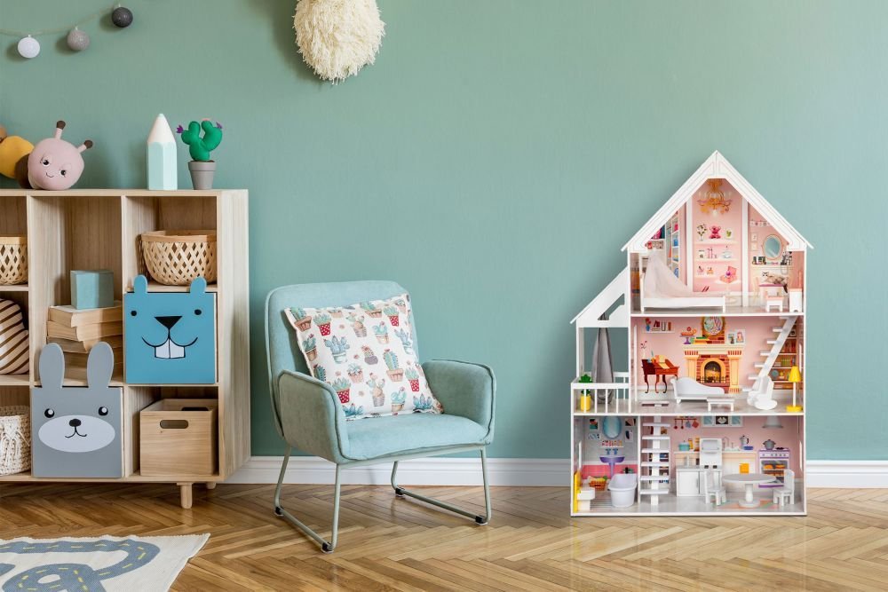 1. Gerardo's Toys wooden dollhouse with LED lights in a children's room setting, next to a blue chair and storage unit