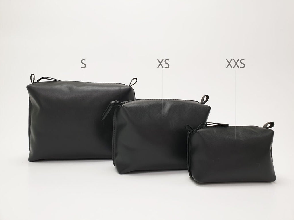 5. Three Zelma Kraft black leather cosmetic bags in different sizes, labeled S, XS, XXS