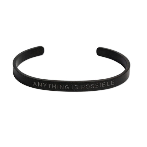 1. Men's matte black Olla bracelet with 'Anything Is Possible' engraving, shown in studio