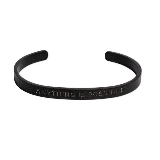 1. Men's matte black Olla bracelet with 'Anything Is Possible' engraving, shown in studio