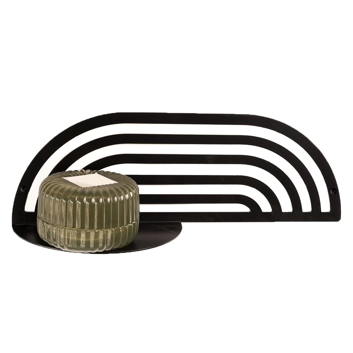 2. Black metal plant shelf with green ribbed pot, showcasing shelf's capacity and design