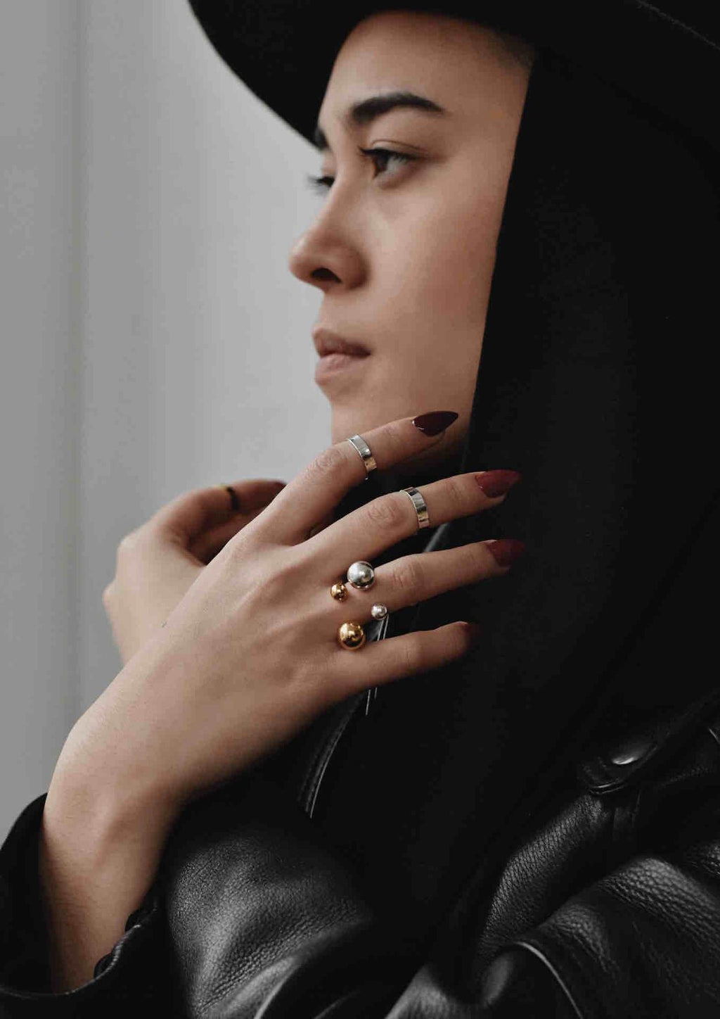 1. Woman wearing NO MORE Big Bomb Multisize Ring in silver, styled with multiple rings, showcasing bold statement jewelry