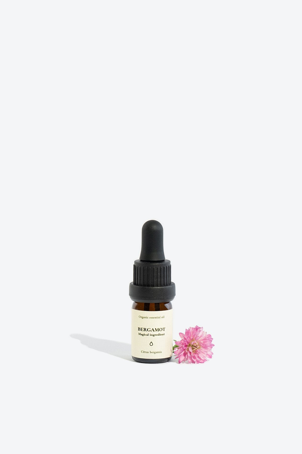 1. Smells Like Spells BERGAMOT Essential Oil in 5 ml glass bottle with pipette, shown with pink flower for lifestyle setting