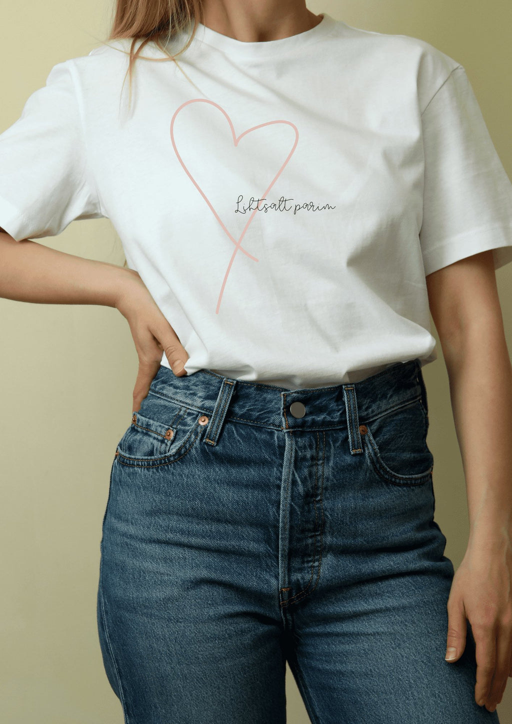 1. Women's white T-shirt with heart design and 'Lihtsalt parim' text, styled with jeans, by Black Giraffe Brand
