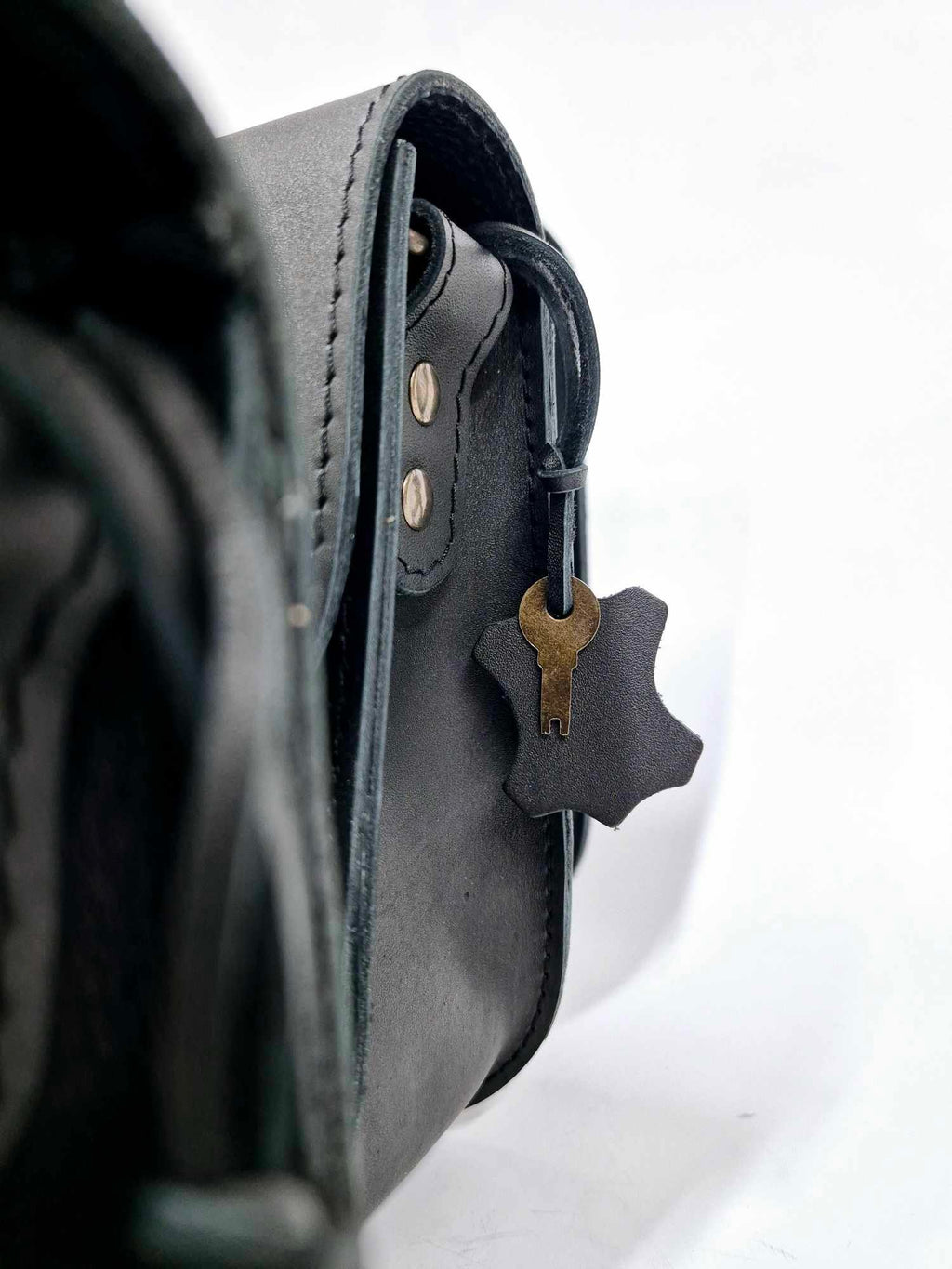 5. Woman holding multiple Zelma Kraft black leather bags, showcasing different styles