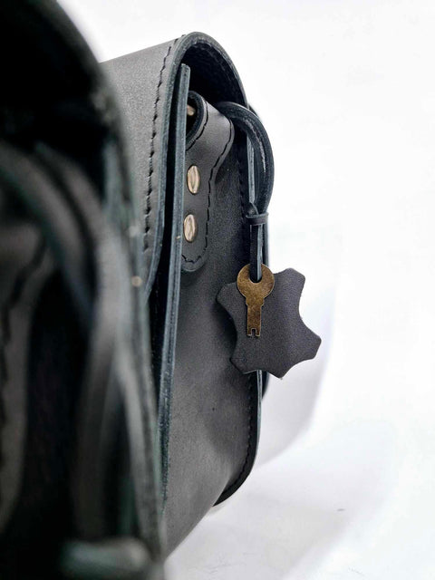5. Woman holding multiple Zelma Kraft black leather bags, showcasing different styles