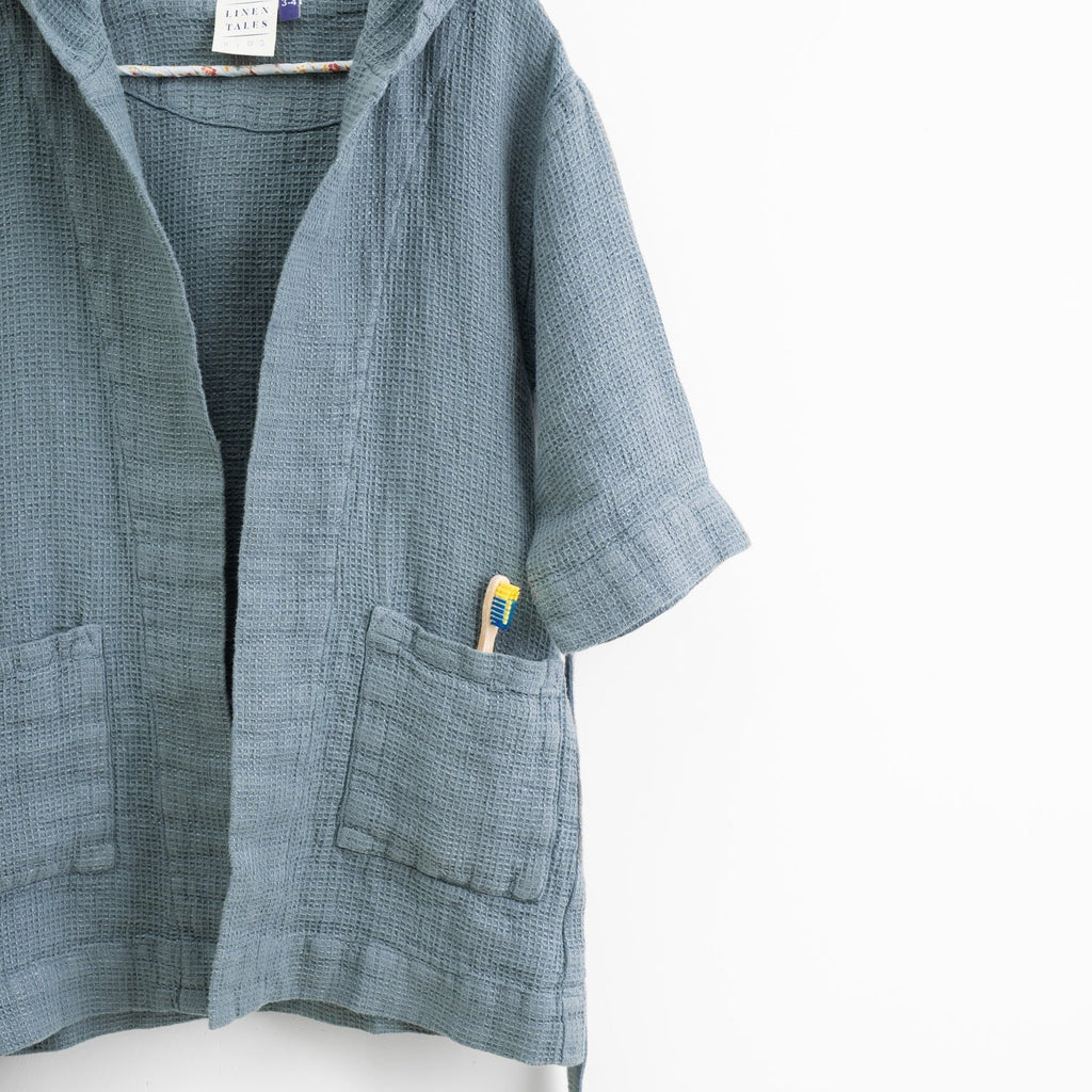5. Close-up of kids' blue fog linen bathrobe showing pocket and hood detail