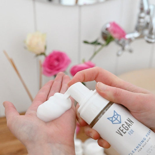 1. Vegan Fox Cleansing Foam being dispensed into hand, 200 ml, in bathroom with flowers