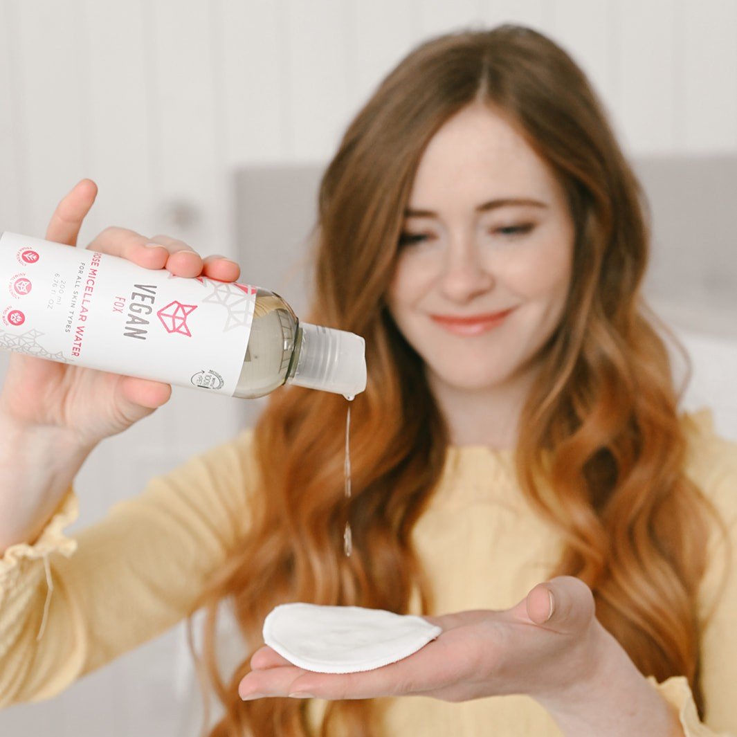 1. Woman using Vegan Fox Rose Micellar Water with cotton pad, showcasing gentle cleansing