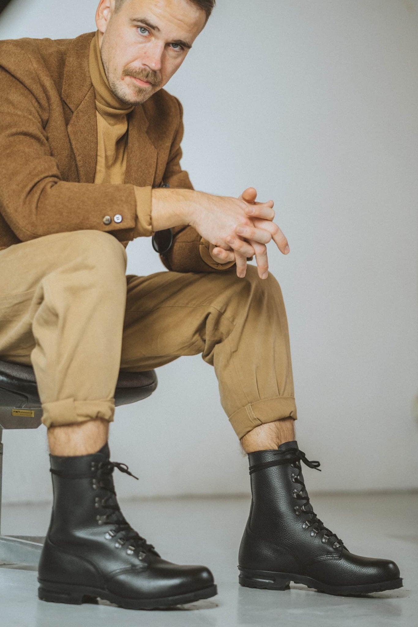 2. Men's M77 Norwegian Combat Boots by Samelin paired with casual outfit, shown in seated pose